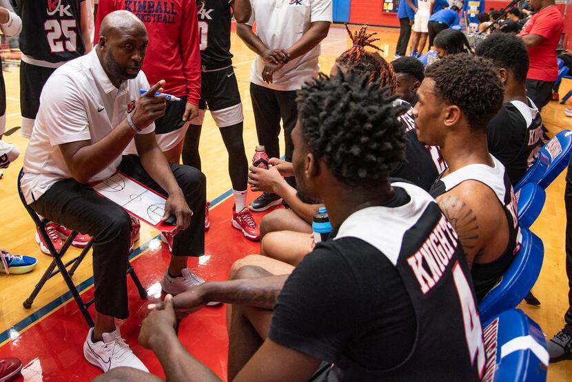 Kimball Head Coach Nick Smith talks to his players during a timeout at Kimball's...