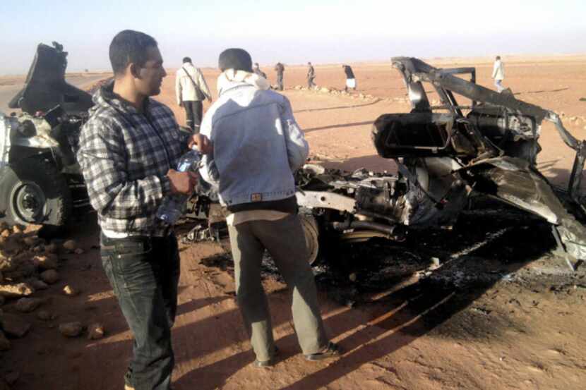 Observers survey wreckage left behind after Algerian rescue attempt.