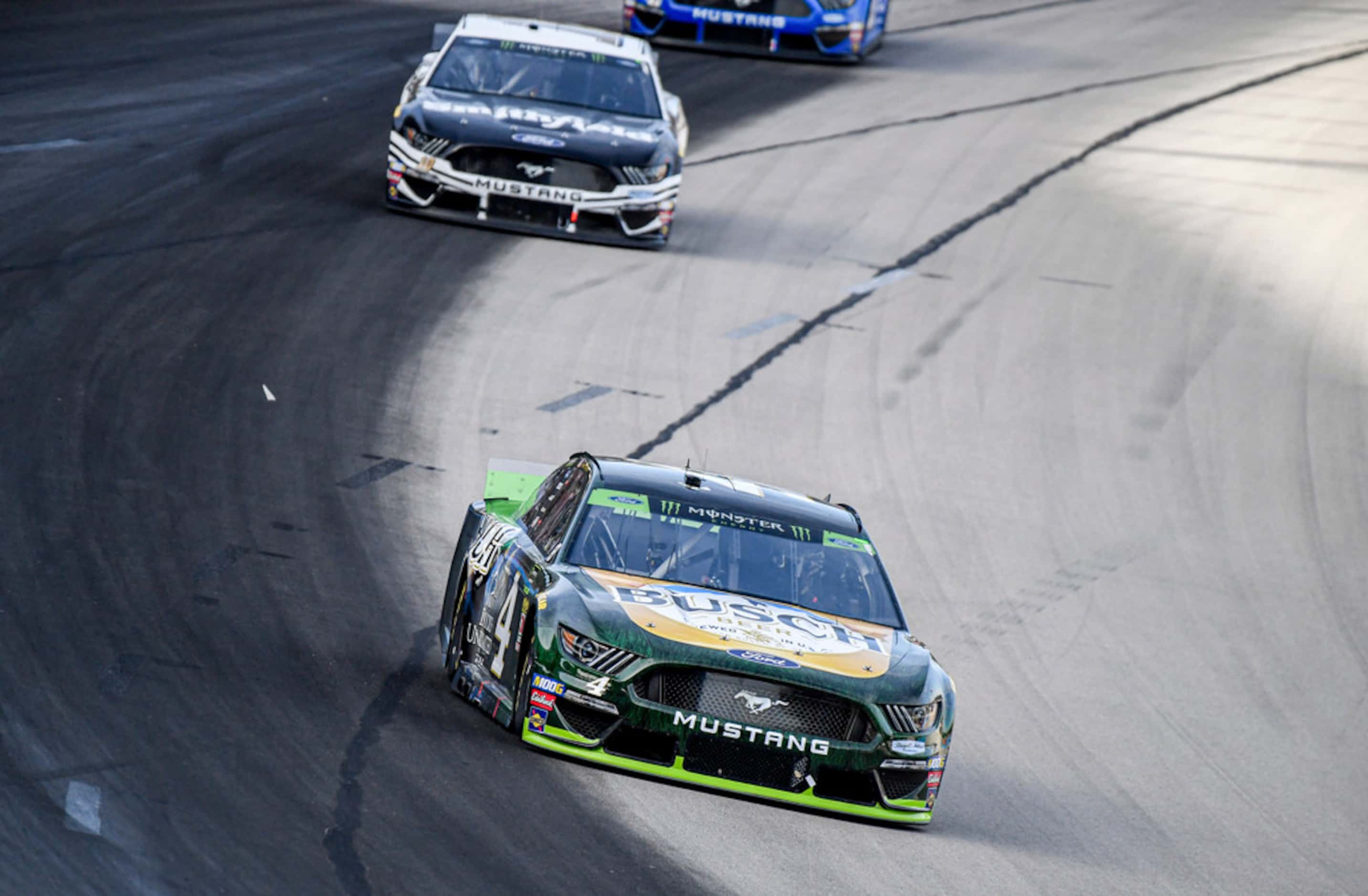 Clint Bowyer (14) and Kevin Harvick (4) battle for position during a NASCAR auto race at...