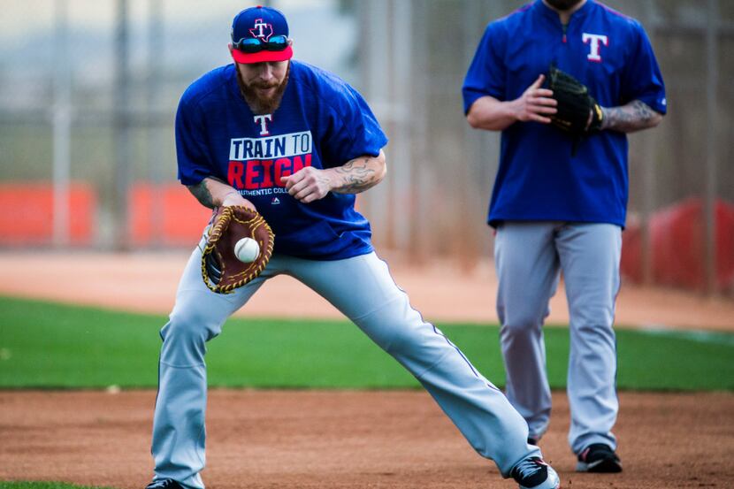 Texas Rangers first baseman Josh Hamilton (32) fields a grounder during a spring training...