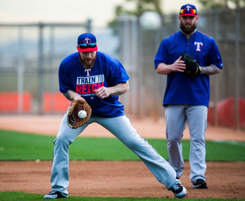 Texas Rangers first baseman Josh Hamilton (32) fields a grounder during a spring training...