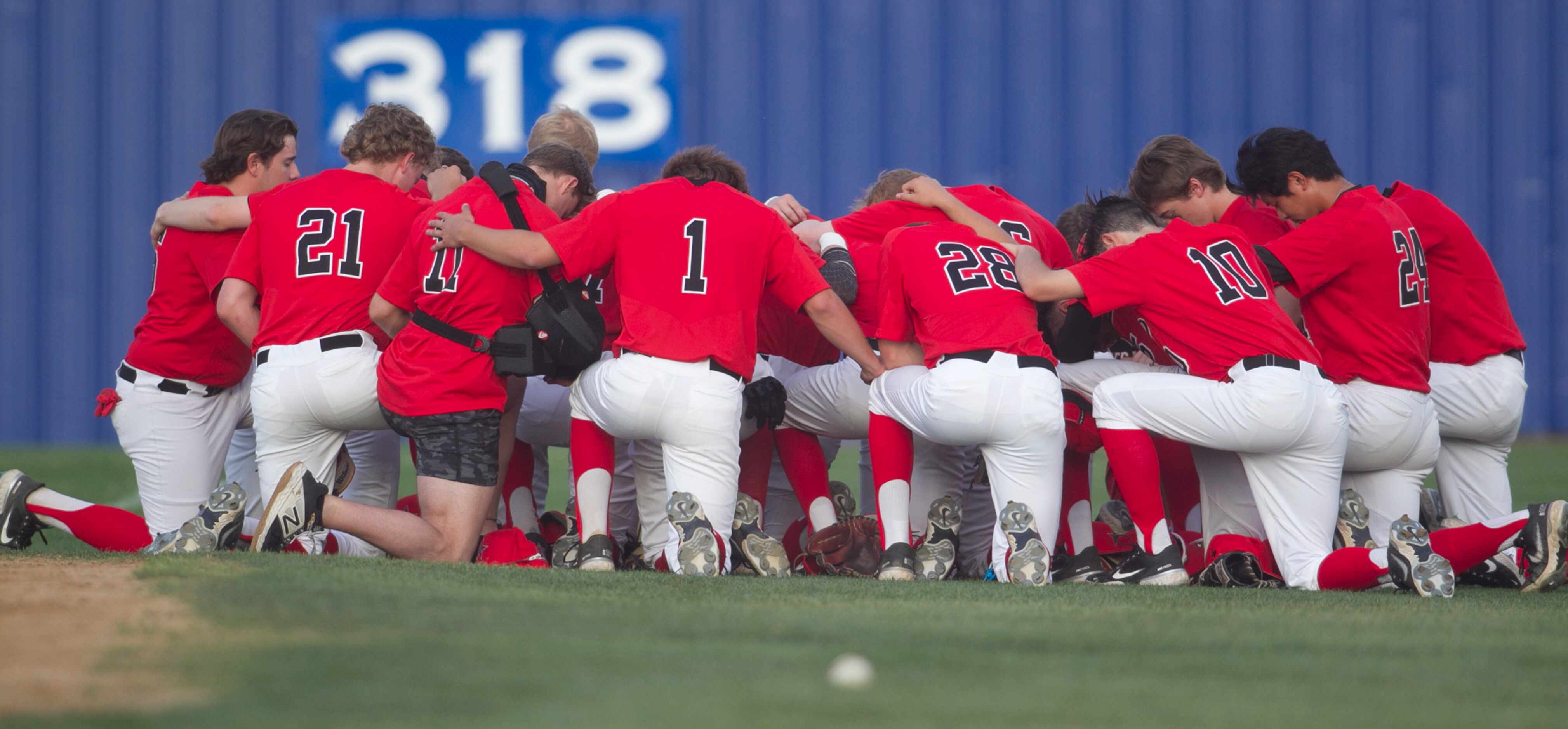 Coppell players pause to pray before the start of their game against Hebron. Coppell won,...