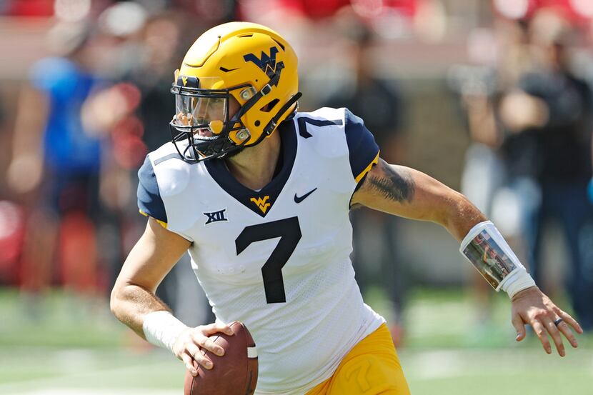 FILE - In this Sept. 29, 2018, file photo, West Virginia's Will Grier (7) looks to pass the...