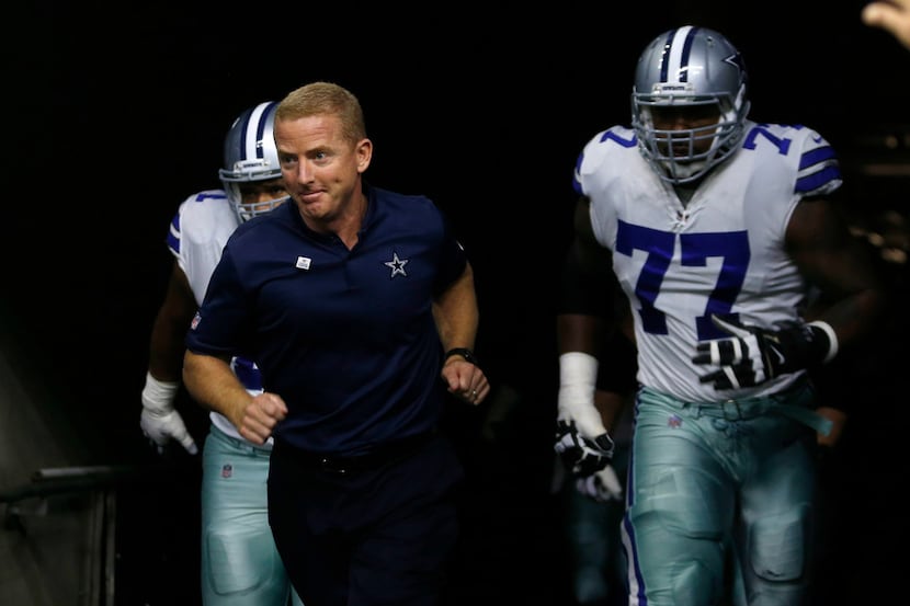 Dallas Cowboys head coach Jason Garrett leads the team onto the field before the start of a...
