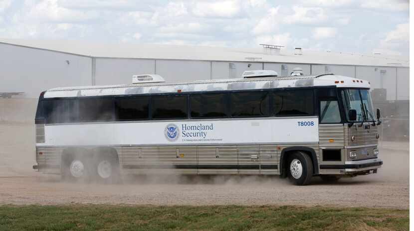 A Homeland Security bus carries detained employees away after the raid at  Load Trail.