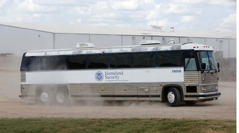 A Homeland Security bus carries detained employees away after the raid at  Load Trail.