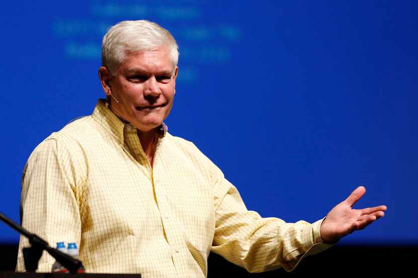 Rep. Pete Sessions, R-Dallas, reacts after the crowd erupted during the question portion of...