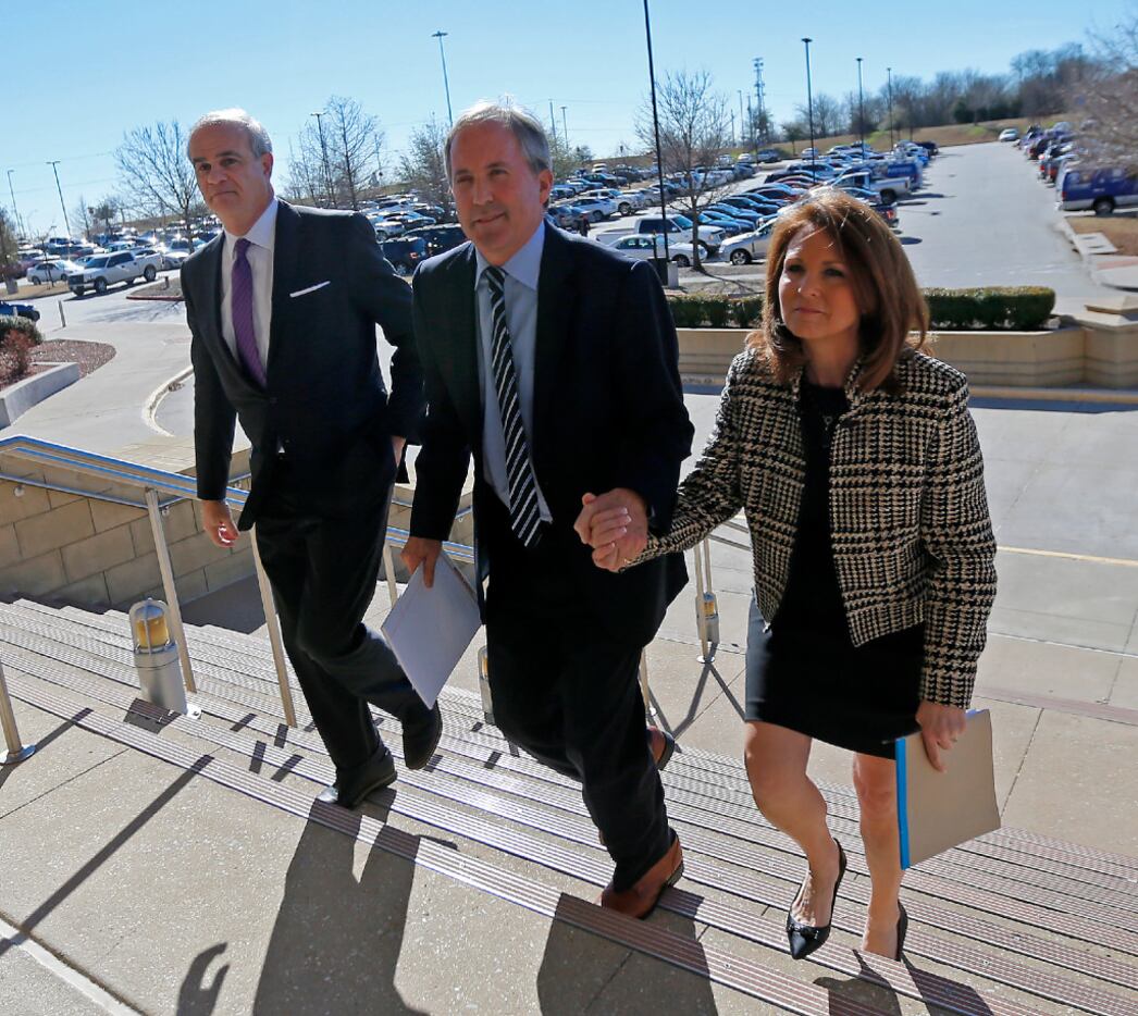 Texas Attorney General Ken Paxton (center) arrives at the Collin County Courthouse with his...