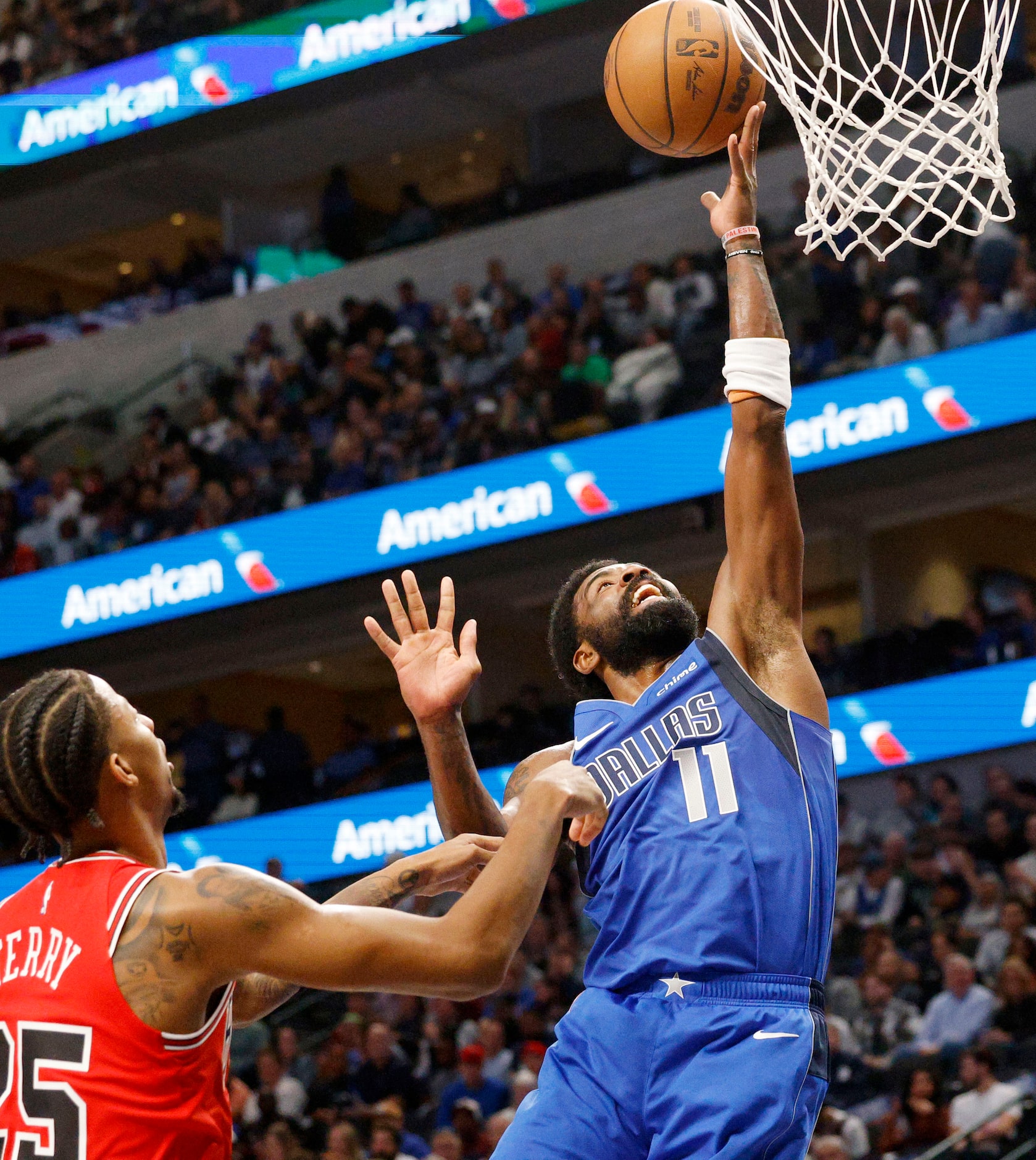 Dallas Mavericks guard Kyrie Irving (11) lays up a ball as Chicago Bulls forward Dalen Terry...