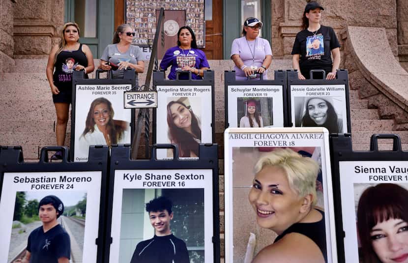 Family members stood with posters of lost loved ones at the old Tarrant County Courthouse on...