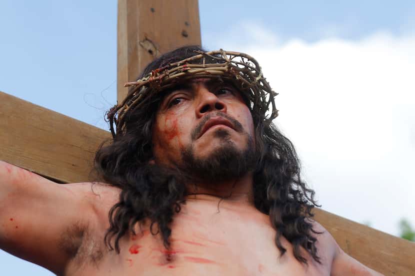 Jesus, as portrayed by Jose Cruz Rodriguez, looks down at the crowd at the re-enactment of...