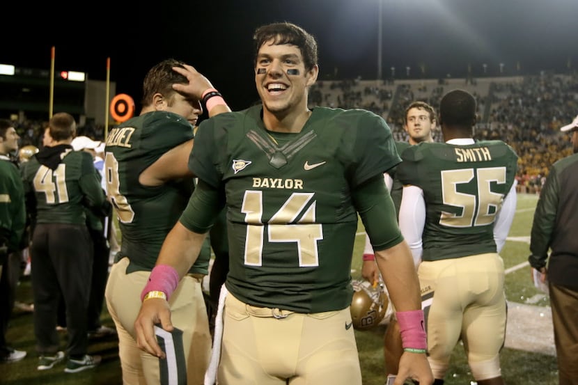 Baylor quarterback Bryce Petty (14) celebrates on the sideline late in the second half of an...