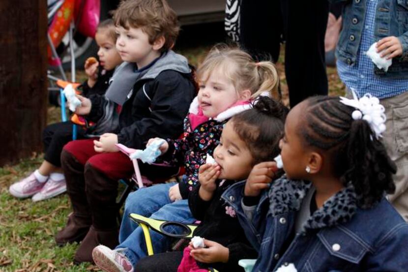 
Children from a local day care enjoy cotton candy during a Martin Luther King parade.

