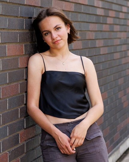 Isabel Gameros, 17, poses outside of Booker T. Washington High School for the Performing and...