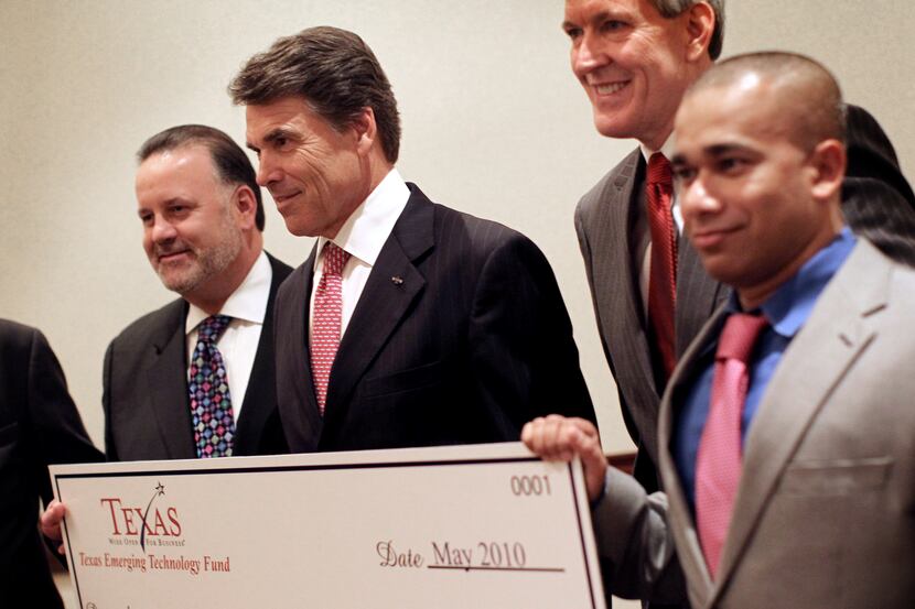 Gov. Rick Perry and Atanu Basu (far right), CEO and president of DataInfoCom Inc., posed for...