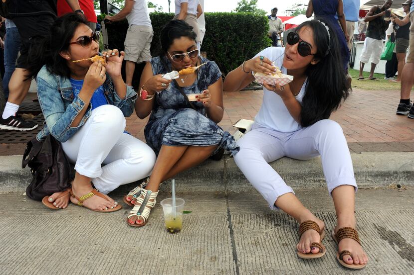 Anisa Din, friend Sheamanti Haque, and sister Anika Din sit and eat their fried delicacies...