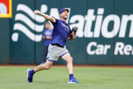 Texas Rangers starting pitcher Max Scherzer throws in the outfield during an off day...