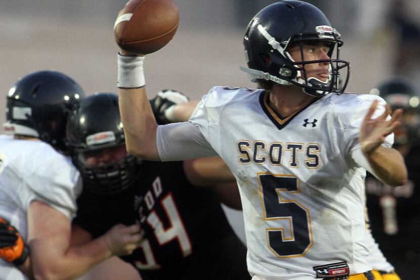 Highland Park Scots quarterback Brooks Burgin (5) passes to an open receiver during the...