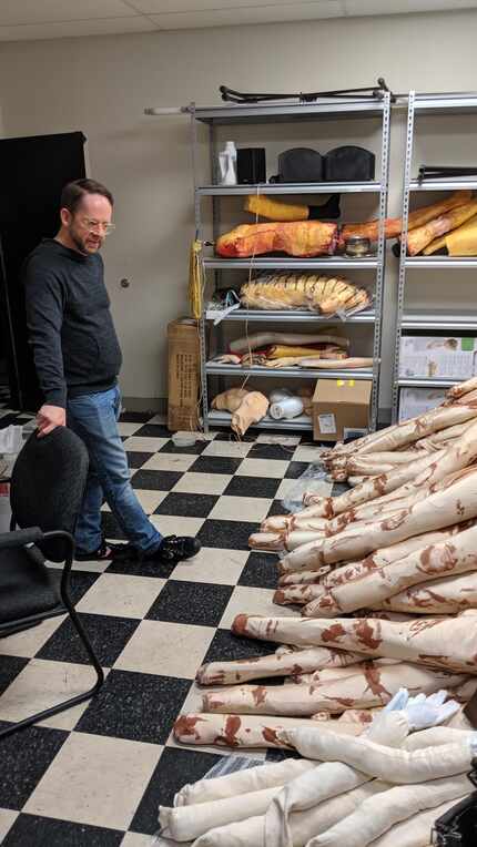 Tim Johnson, director of "Gary: A Sequel to Titus Andronicus," looks over a stack of faux...