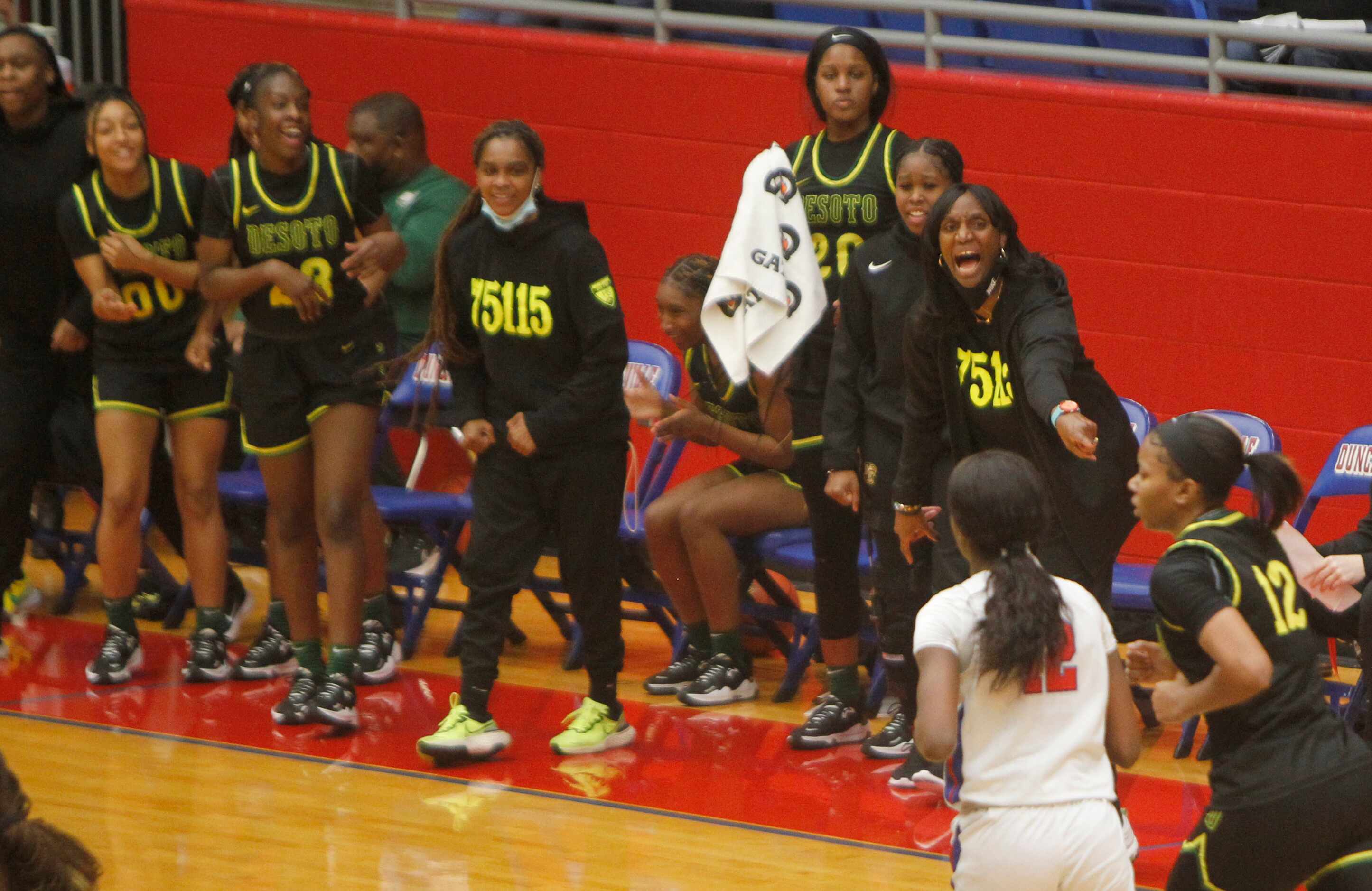 DeSoto head coach Andrea Robinson directs her players from the team bench area during first...