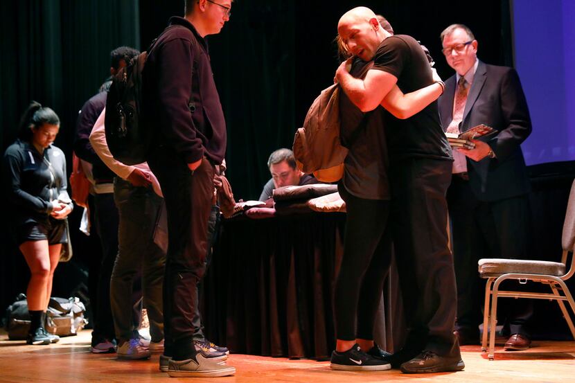 Suicide survivor, activist, storyteller and filmmaker Kevin Hines (right) comforts a student...