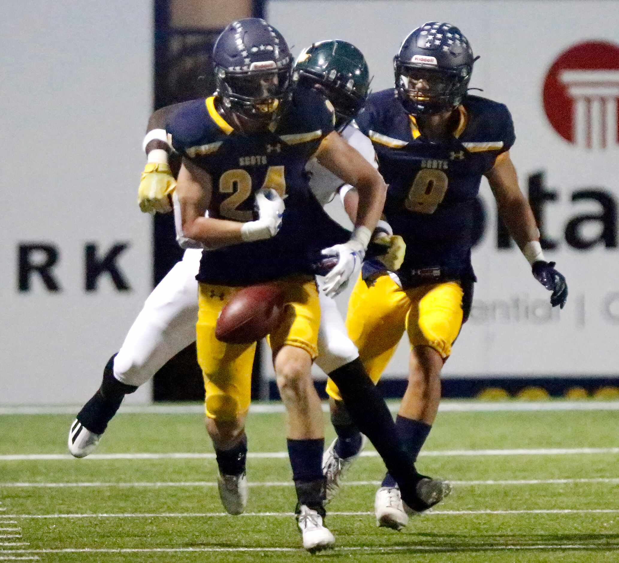 Highland Park High School free safety Preston Taylor (24) fumbles the football after making...