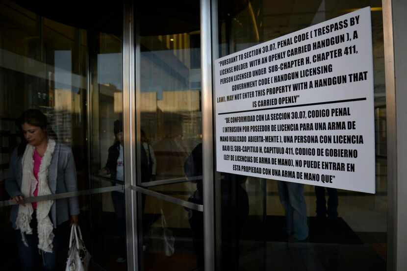 A sign informs people at Dallas' George Allen Sr. Courts Building that handguns are...