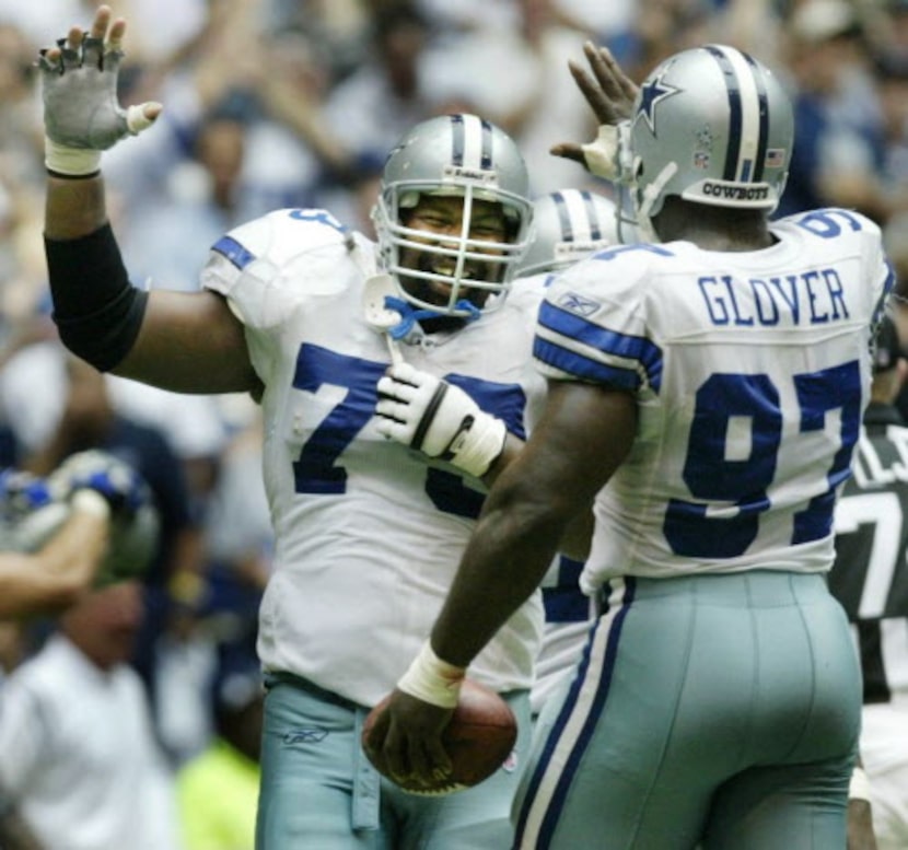 October 12, 2003 -- Dallas lineman Larry Allen (73)  congratulates teammate La'Roi Glover in...