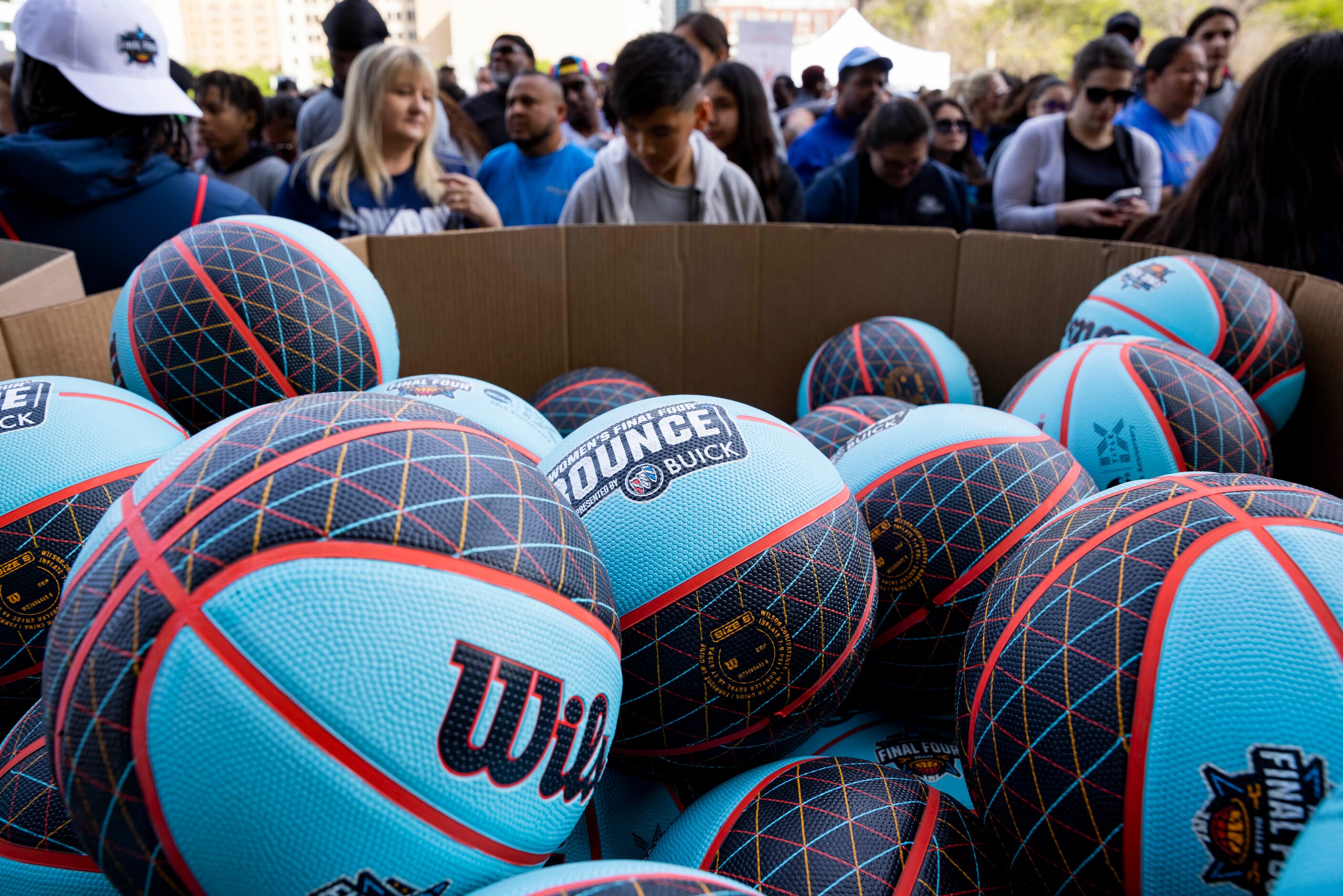 Basketballs wait to be passed out before people dribble their way from City Hall to Tourney...