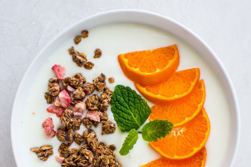 Homemade yogurt can be made in a variety of ways and then be topped with granola and fruit.