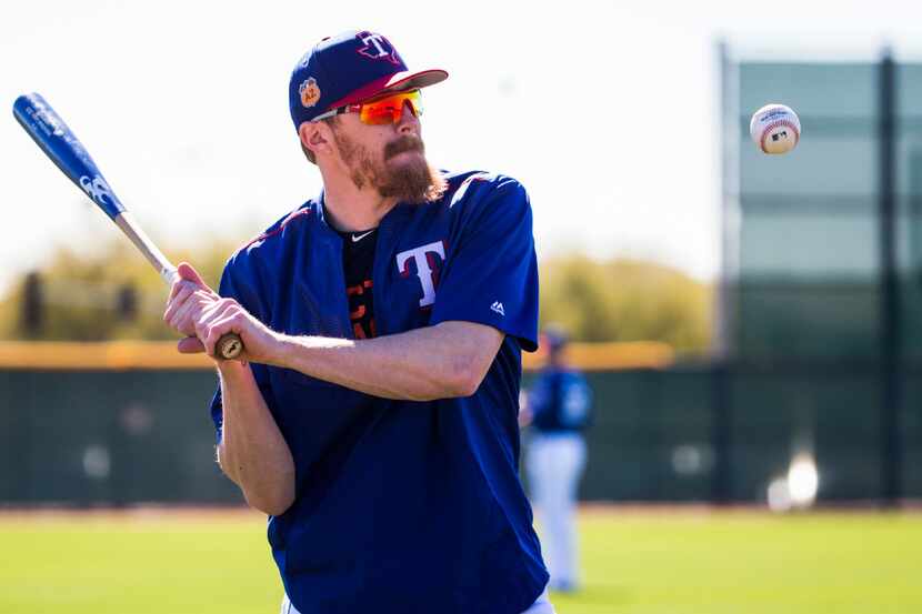 Texas Rangers relief pitcher Jake Diekman (41) plays with a bat and ball during a workout at...