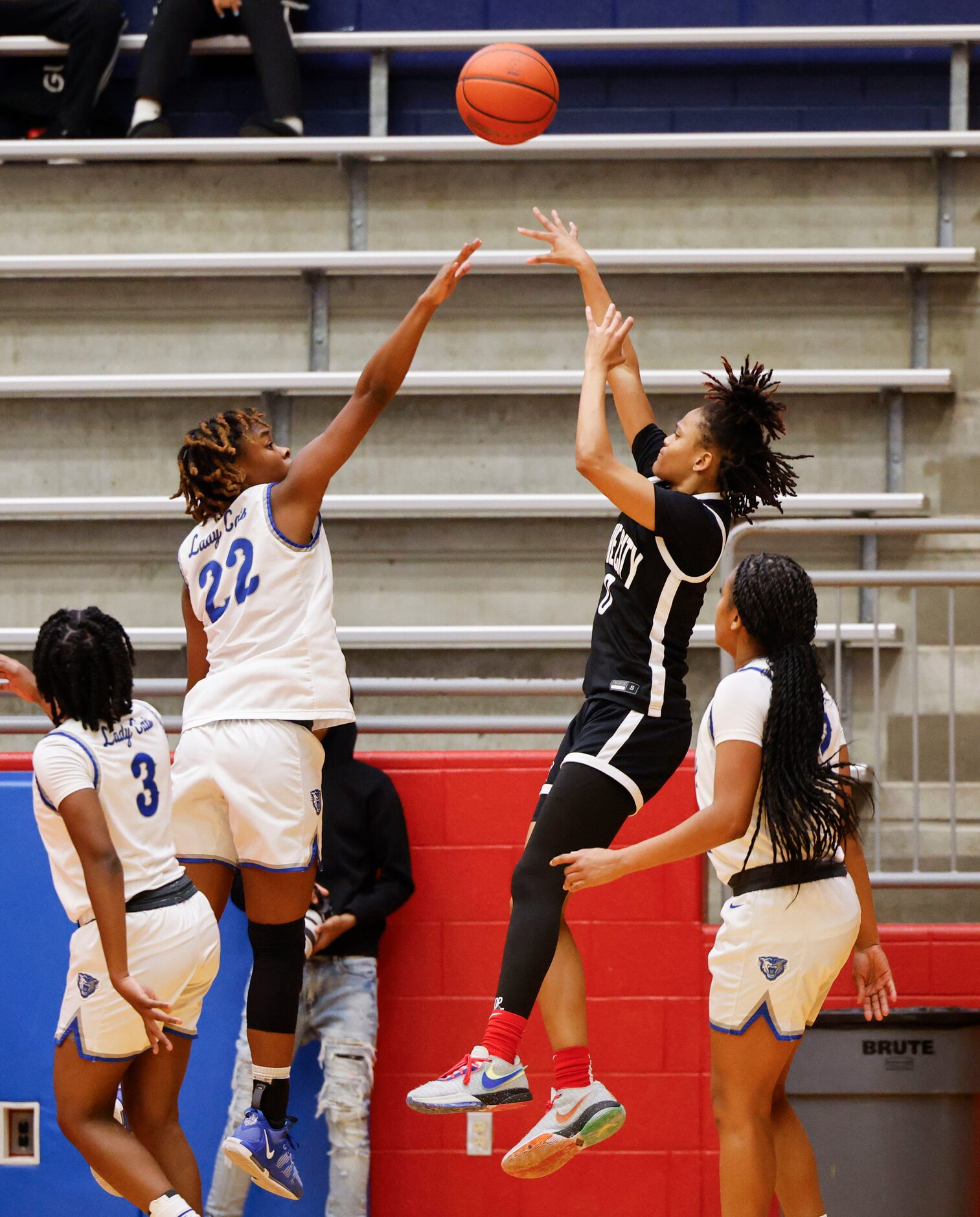 Conway high’s Alivia Cox (22) reaches to block a three-pointer of Duncanville high’s Chloe...