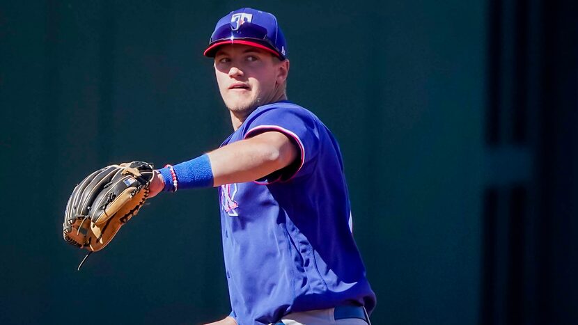 Texas Rangers infielder Josh Jung warms up at third base during the fifth inning of a spring...