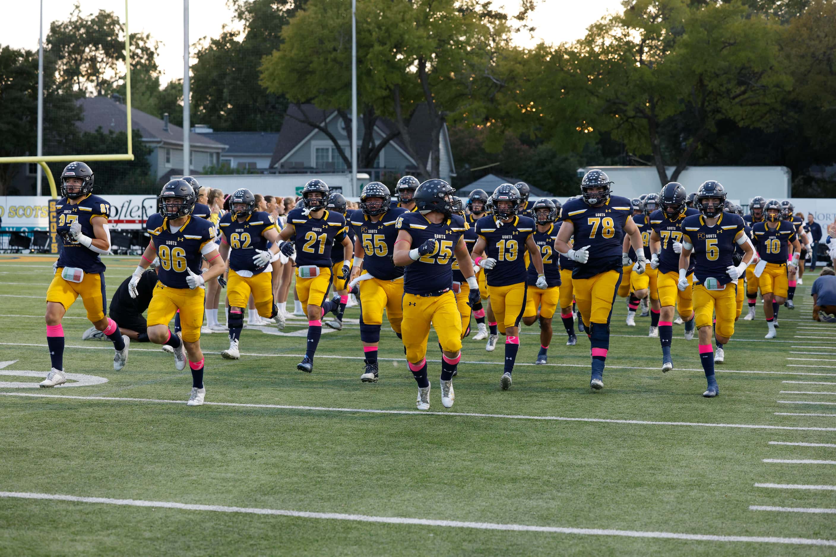 The Highland Park football team takes the field before the first half of a District 7-6A...