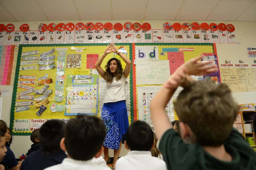 Kindergartner dual-language teacher Raquel Rodriguez sings a song in Spanish during class at...