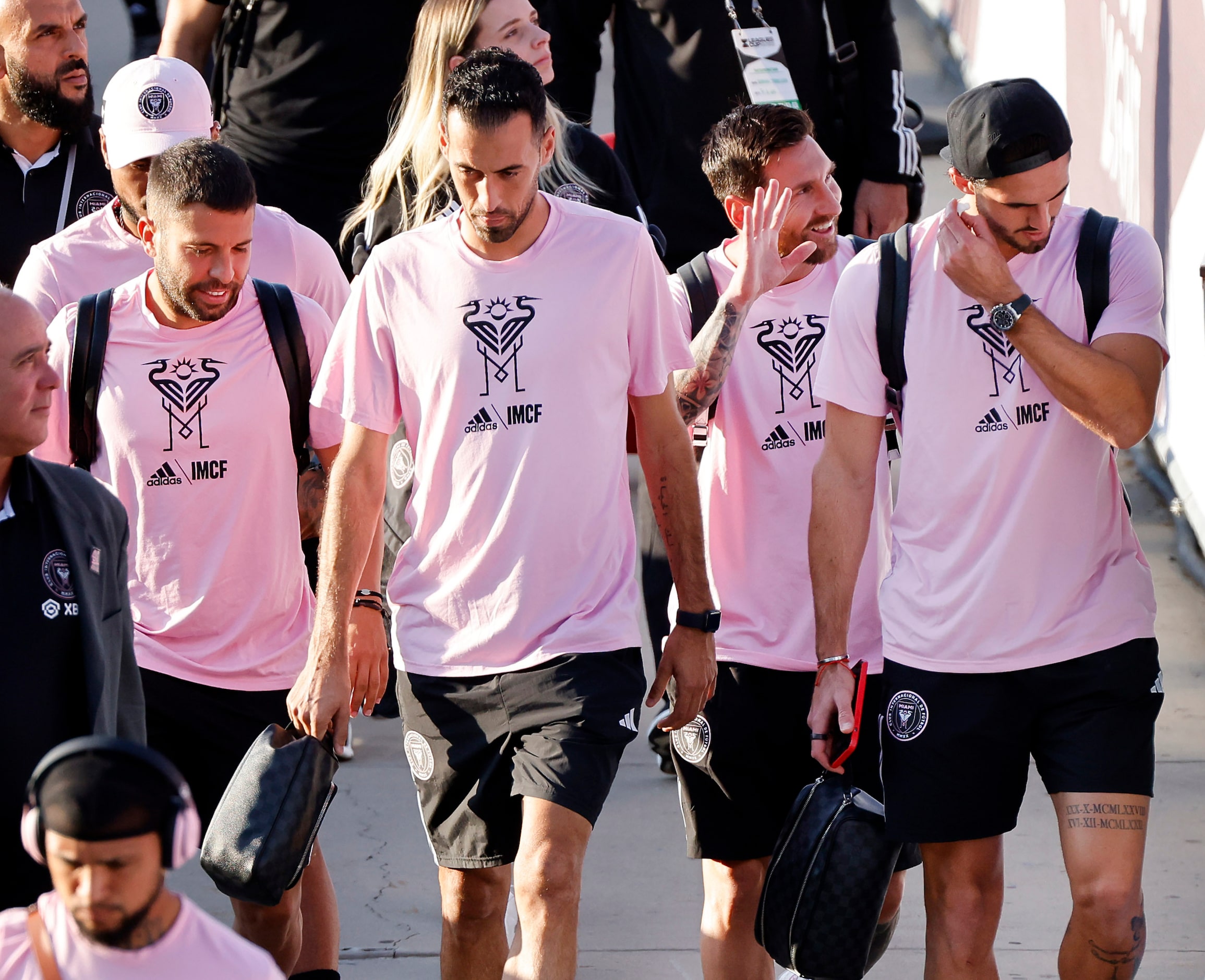 Inter Miami forward Lionel Messi (second from right) waves to a fan as he arrives with his...