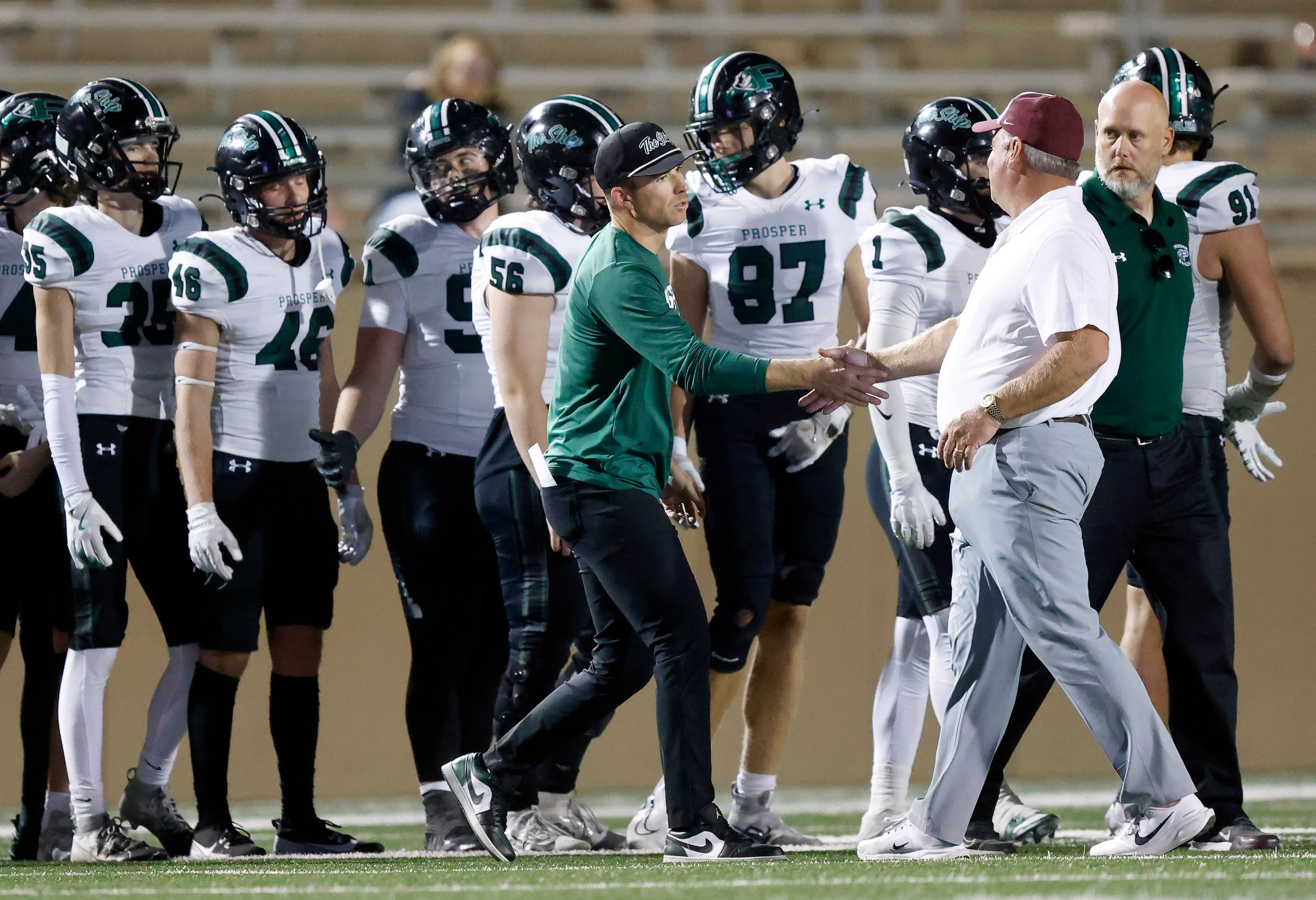 Prosper High head football coach Tyler Moore (left) shakes hands with Plano High head coach...