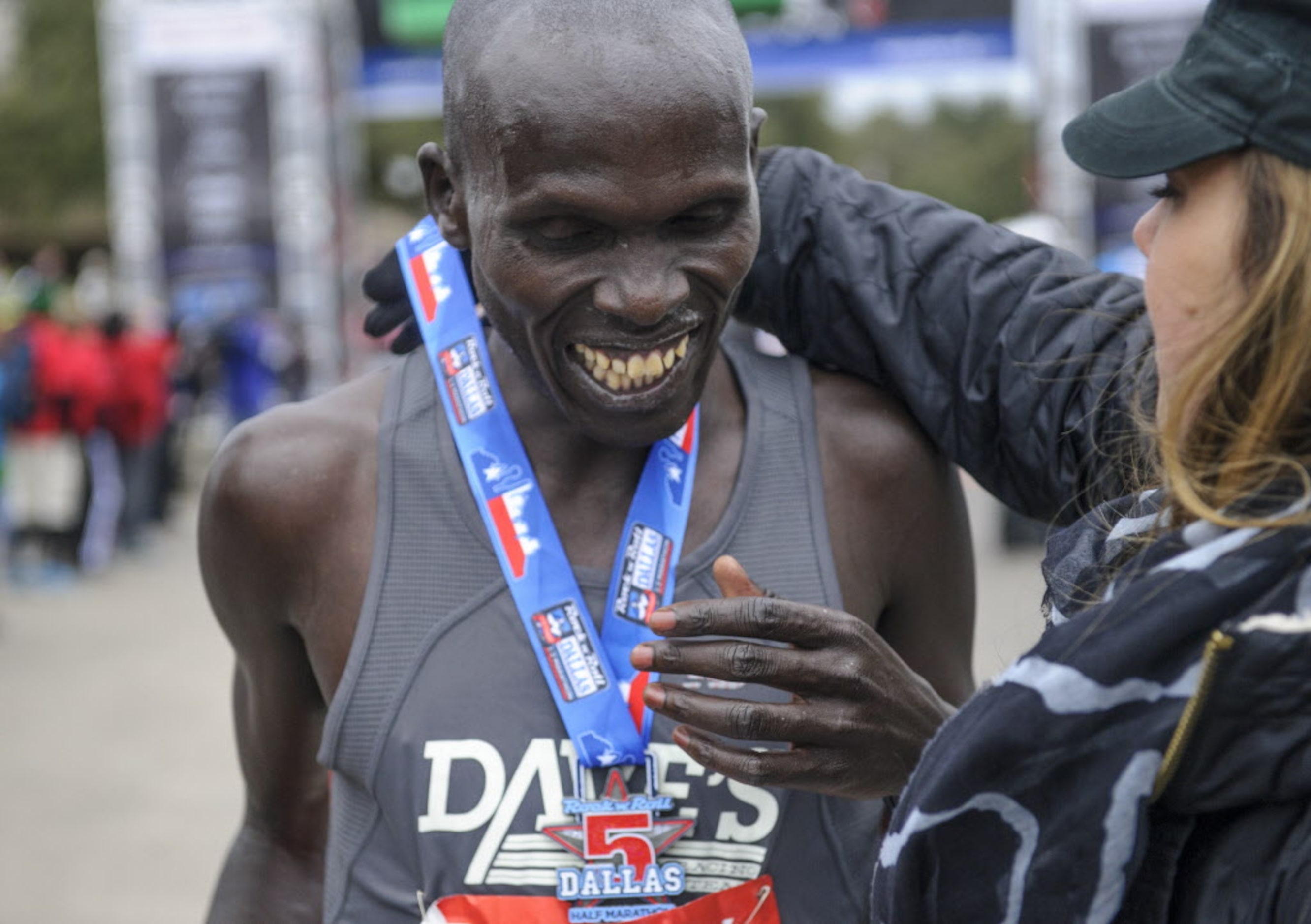 Men's overall winner Julius Kiptoo from Kenya smiles as he is awarded a Rock N' Roll medal...