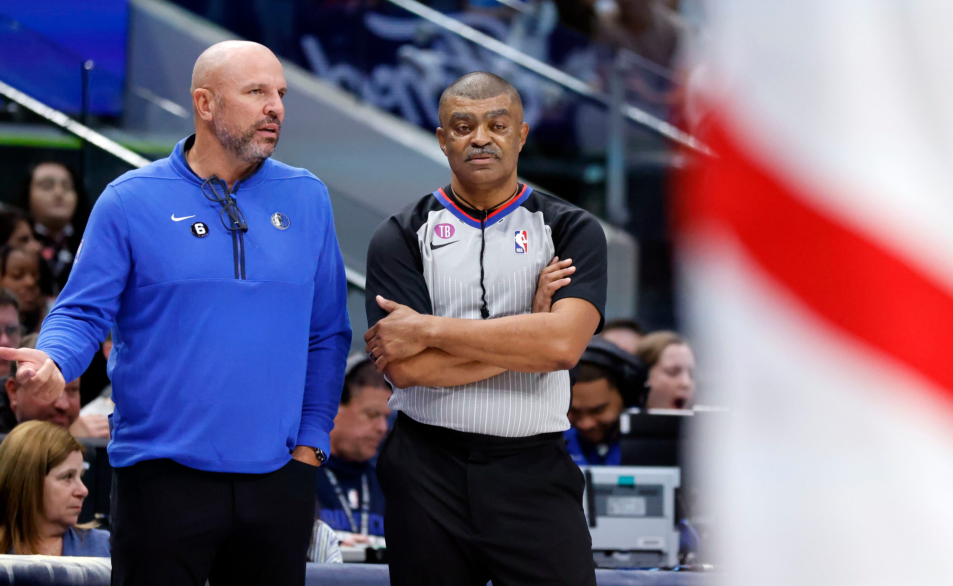 Dallas Mavericks head coach Jason Kidd (left) tries together a foul explanation from referee...