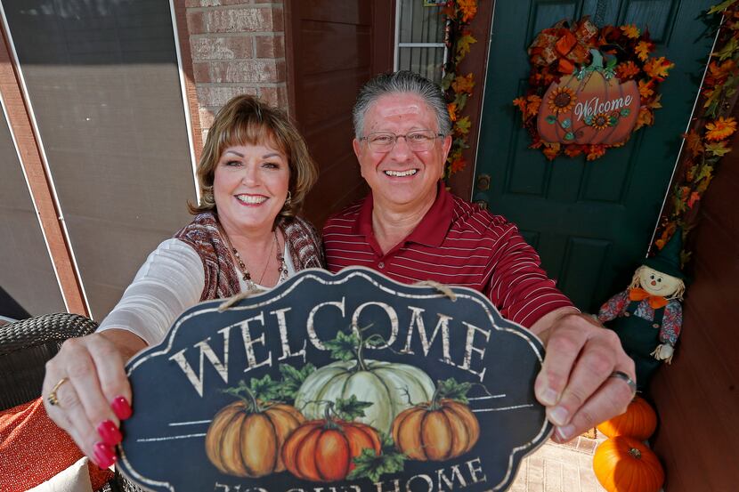 Maretta and Mitch Chokas, in the front doorway of their Mansfield home, host up to 50 people...