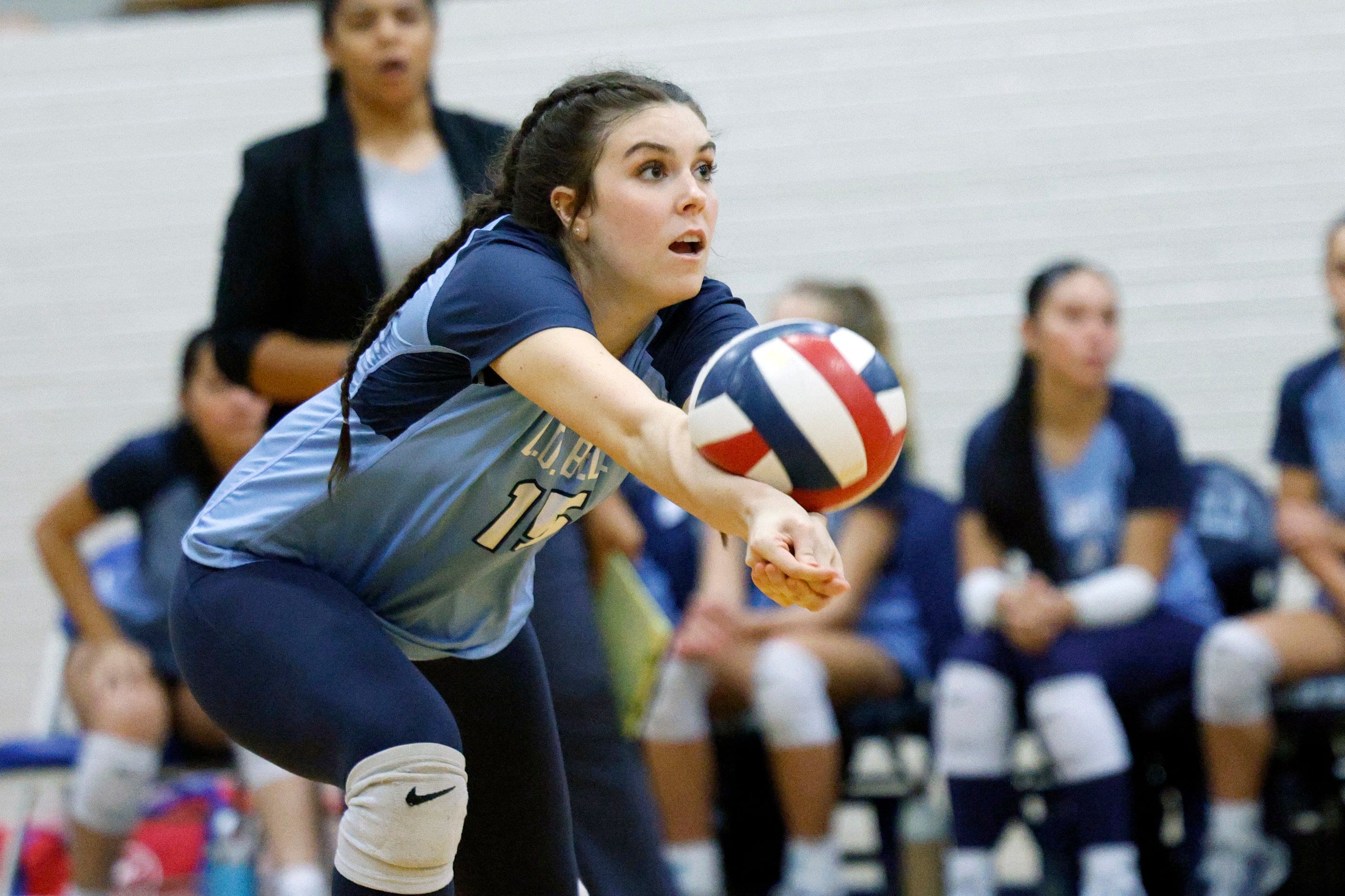 L.D. Bell's Ava Russell (15) digs the ball during a volleyball match against the Trophy Club...