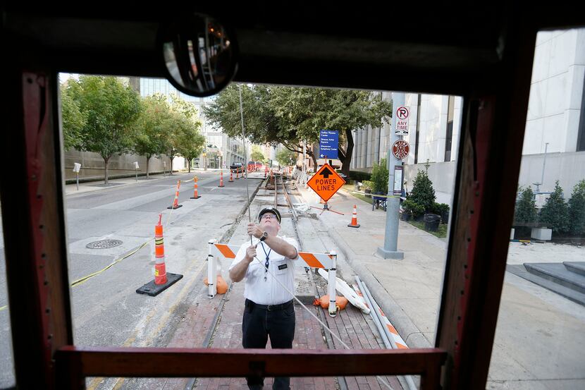 M-Line Trolley motorman Leo Tresp switches the ends of the vehicle's cable at the route's...