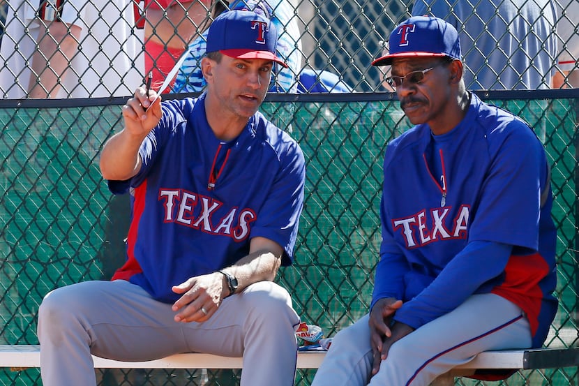 Bench coach Tim Bogar, left, talks with manager Ron Washington during an intrasquad game at...
