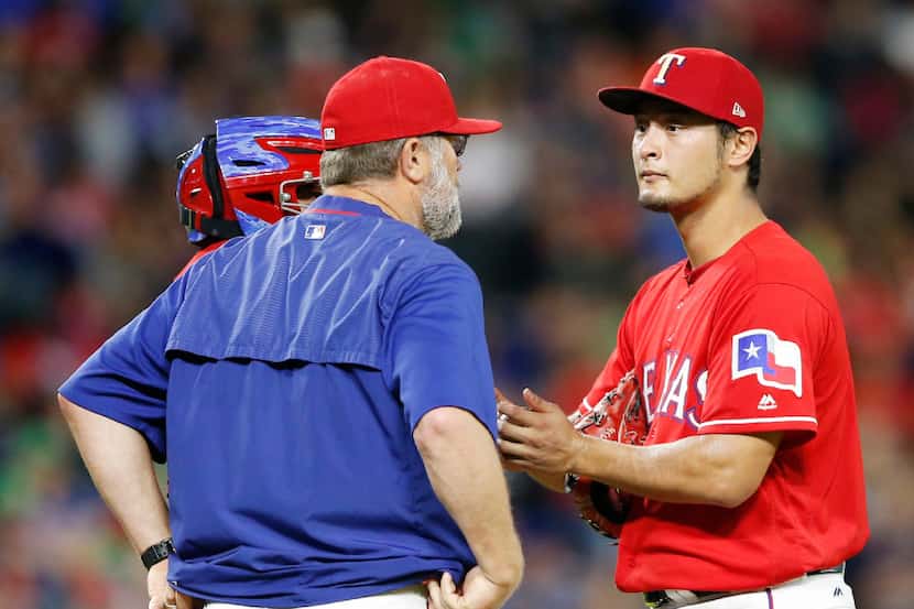 Texas Rangers starting pitcher Yu Darvish (11) listens to Texas Rangers pitching coach Doug...