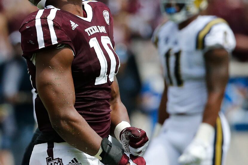 ]Texas A&M Aggies defensive lineman Daeshon Hall is pictured after a defensive stop during...