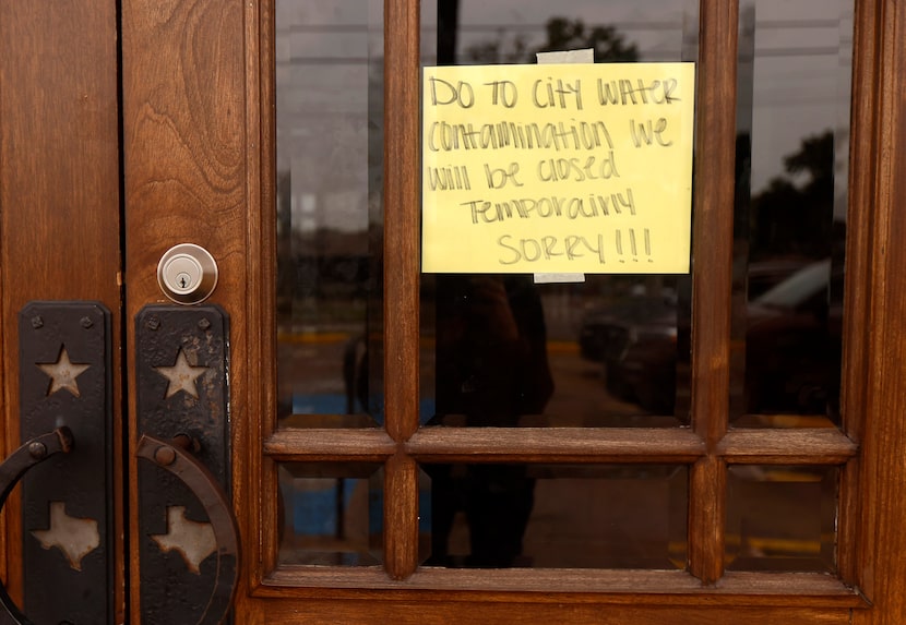 A sign notified Outlaw’s Barbecue customers that they will be closed due to water...