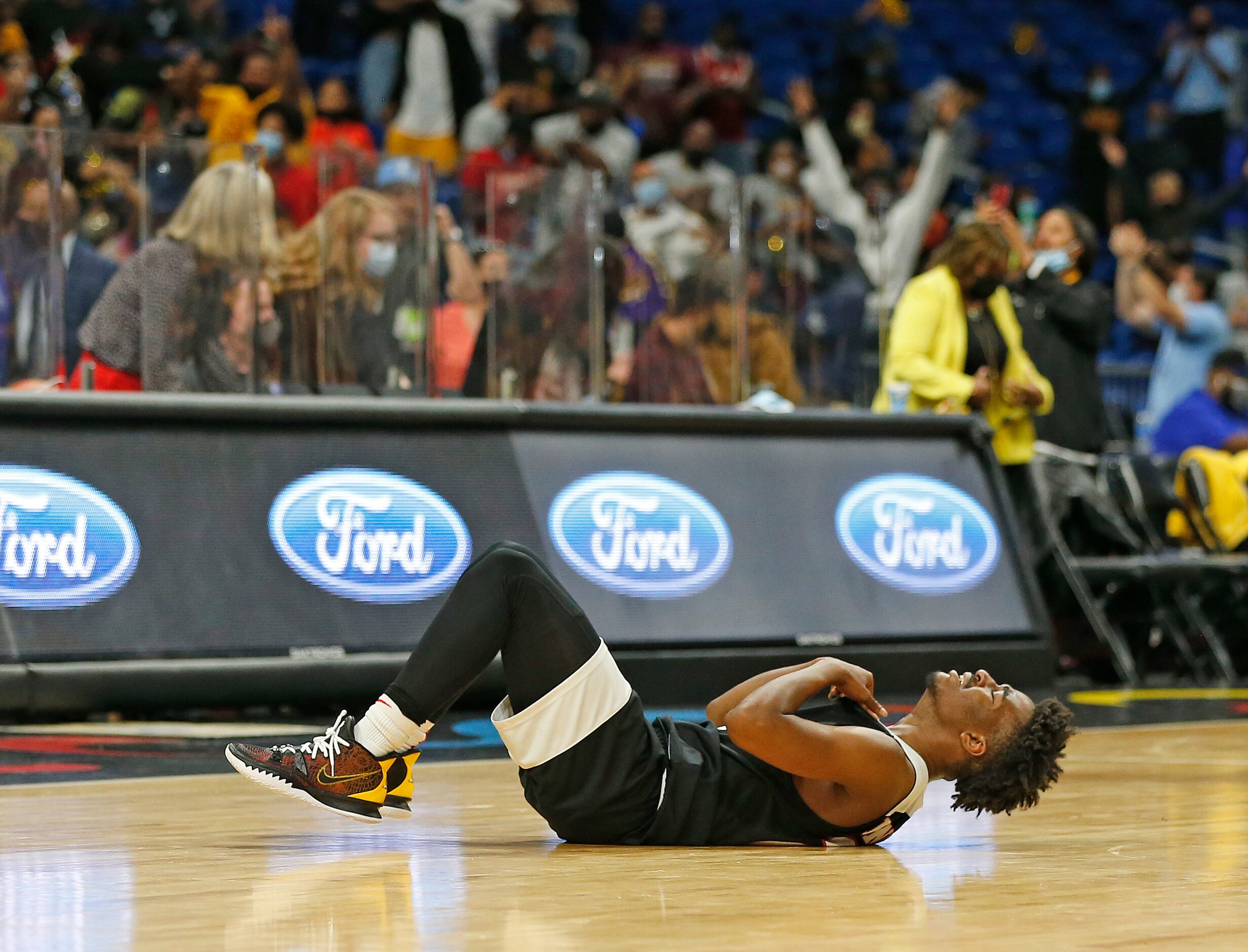 Kimbal players react after losing in OT to Beaumont. UIL boys Class 5A basketball state...