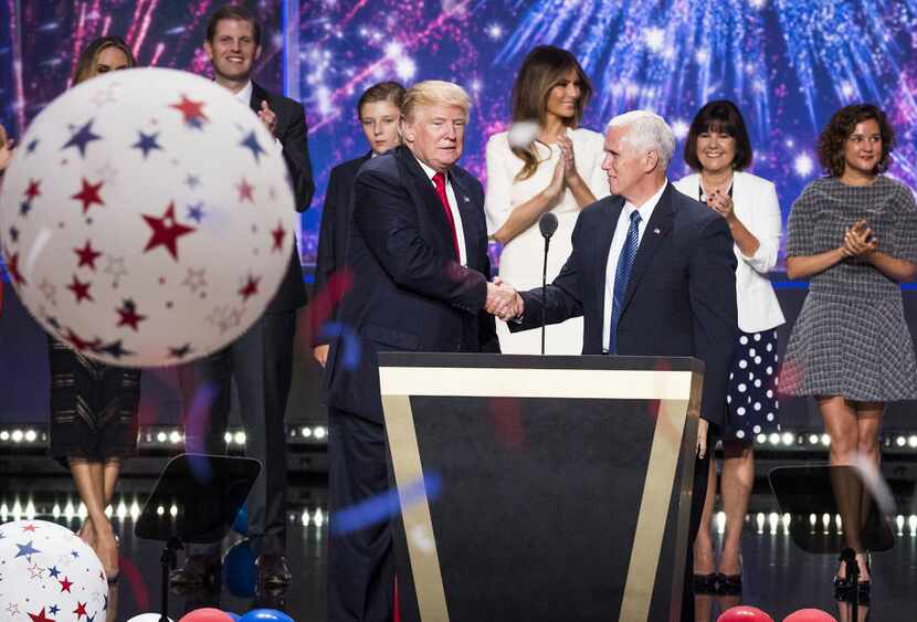 Donald Trump and Mike Pence shake hands as the Republican National Convention comes to a...