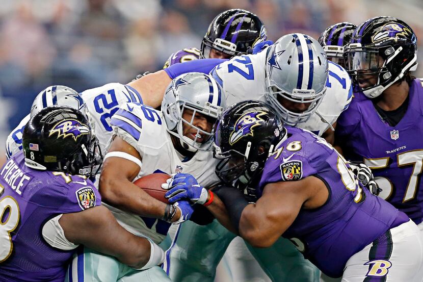 Dallas Cowboys running back Alfred Morris (46) is brought down by Baltimore Ravens defensive...