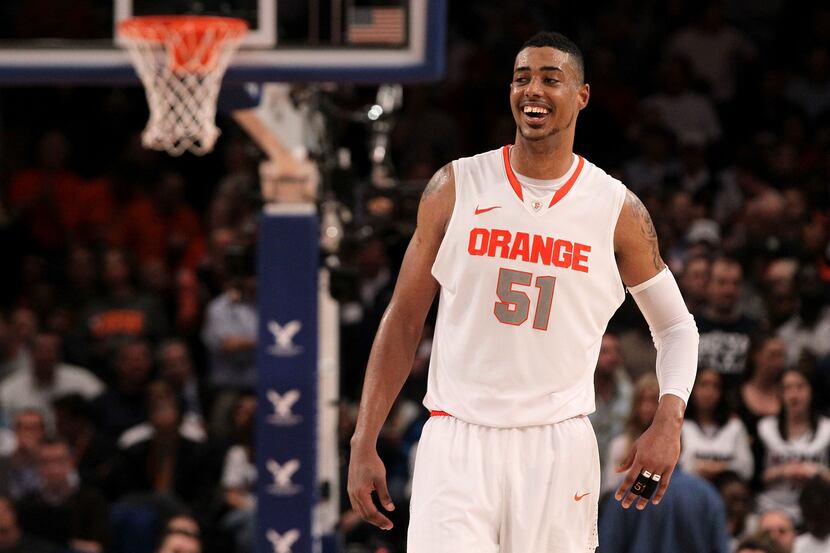 NEW YORK, NY - MARCH 08:  Fab Melo #51 of the Syracuse Orange reacts against the Connecticut...